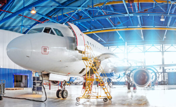 Panoramic view of aerospace hangar, civil aviation aircraft, repair and maintenance of mechanical parts in an industrial workshop. Panoramic view of aerospace hangar, civil aviation aircraft, repair and maintenance of mechanical parts in an industrial workshop
